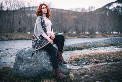 Young woman sitting on rock