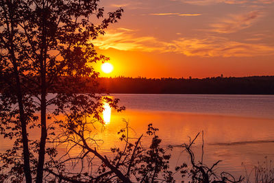 Scenic view of lake against orange sky