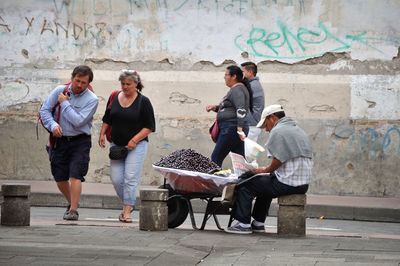 People standing against graffiti wall