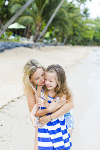 Happy mother with girl at beach