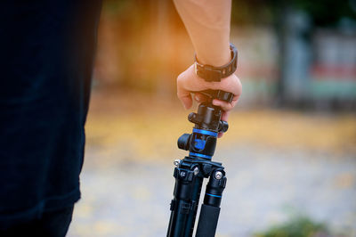 Close-up of hand holding tripod