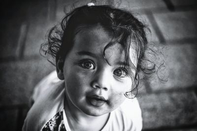 Close-up portrait of girl kneeling on floor at home