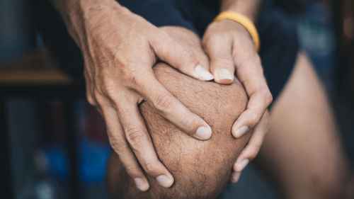 Close-up of man holding hands