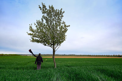 Full length of man standing on field against sky