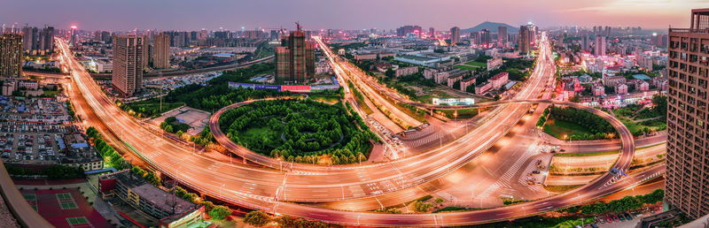 Panoramic view of illuminated roads and buildings in city