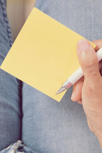 Close-up of human hand holding paper