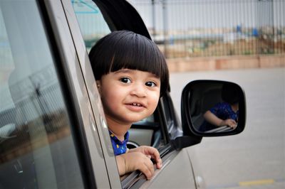 Portrait of smiling girl in car