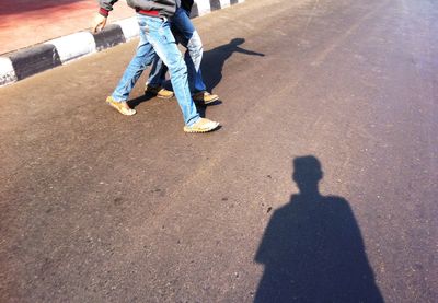 Low section of people walking on road