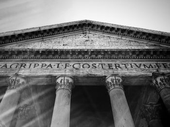 Low angle view of text on building against sky