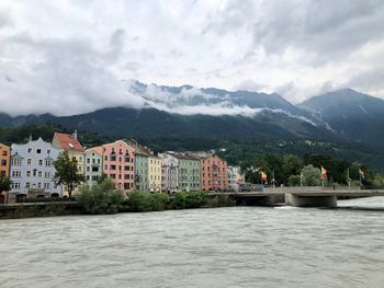 River by buildings against sky in city