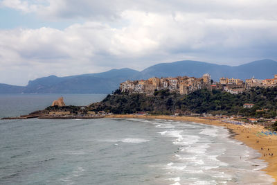 Scenic view of sea and mountains against sky