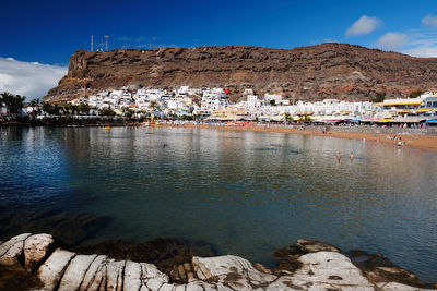 Sea with buildings in background