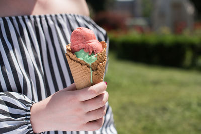 Close-up of hand holding ice cream cone