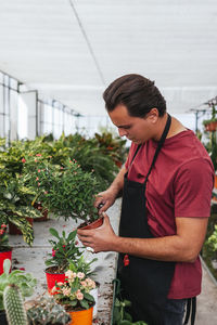 Full length of woman standing in greenhouse