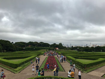 People at farm against sky