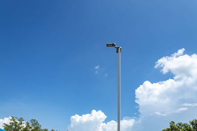 Low angle view of street light against blue sky