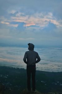 Rear view of man looking at sunset