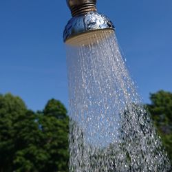 Close-up of water splashing against clear sky