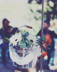 Close-up of man with flowers against blurred background