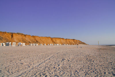Scenic view of desert against clear blue sky