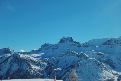 Scenic view of snowcapped mountains against clear blue sky