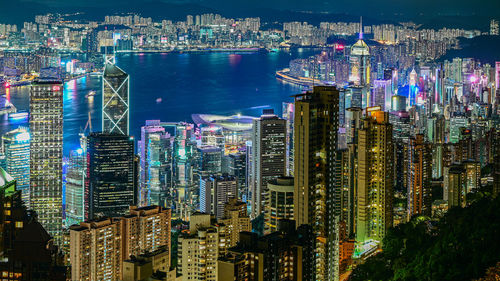 High angle view of illuminated buildings in city at night