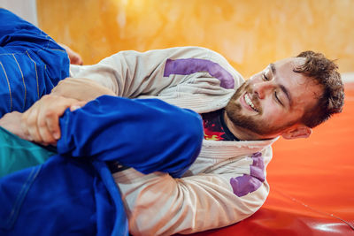 Portrait of young man lying on bed