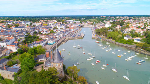 High angle view of town by sea against sky