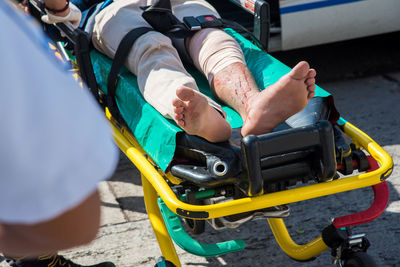 Low section of wounded man lying on stretcher