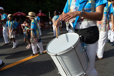 Rear view of man playing drum