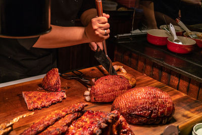 Midsection of man preparing food on table