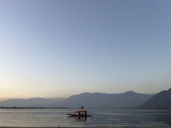 A shikara amidst the serenity and calm of dal lake, srinagar, kashmir