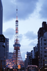 Low angle view of illuminated buildings against cloudy sky