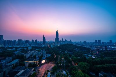 Aerial view of city buildings during sunset