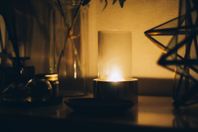 Close-up of illuminated tea light candles on table