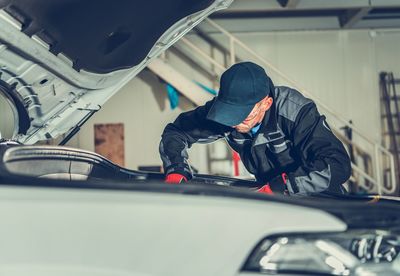 Mechanic repairing car at auto shop