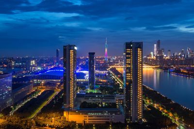 High angle view of illuminated buildings against sky at night