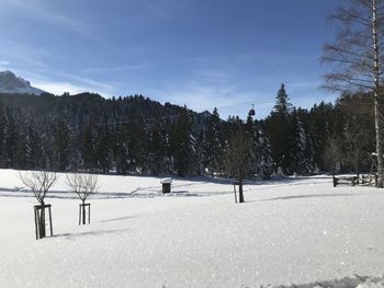 Snow covered field against sky