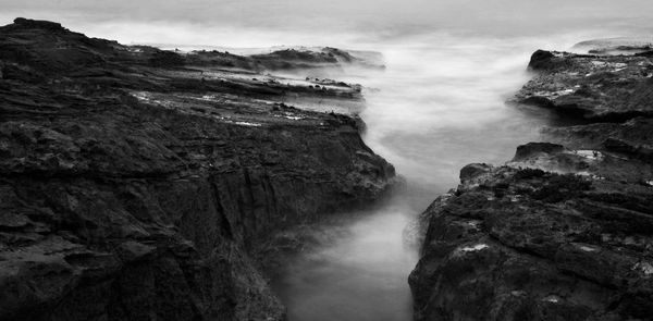 Low angle view of waterfall against sky