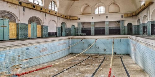 Abandoned swimming pool without water