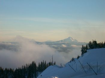 Scenic view of snow covered mountains against sky