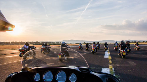 Rear view of bikers on runway