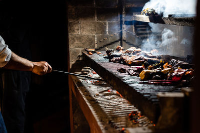 Man working on barbecue grill