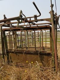 Abandoned train on field against sky