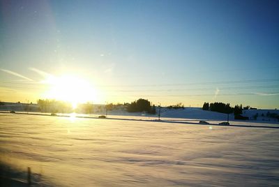 Scenic view of frozen lake against sky during sunset