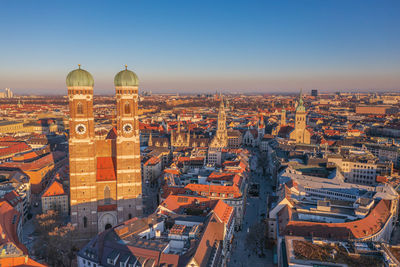 High angle view of city buildings against clear sky