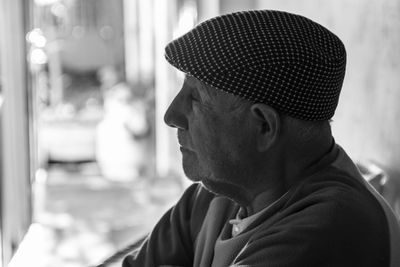 Close-up of senior man wearing flat cap