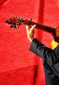 Cropped hand of man playing guitar