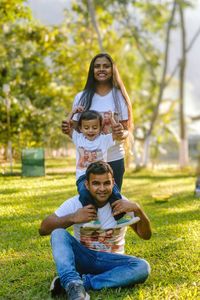 Portrait of young woman sitting on field