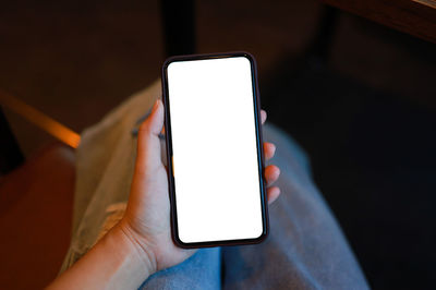 Close-up of hand holding mobile phone